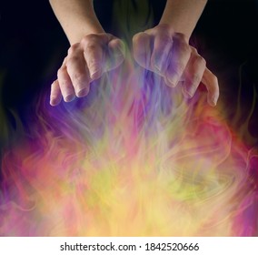 White Witch Sensing Ectoplasmic Activity - female hands sensing a gaseous field of vibrant colourful ectoplasmic matter on a  black background with copy space 
