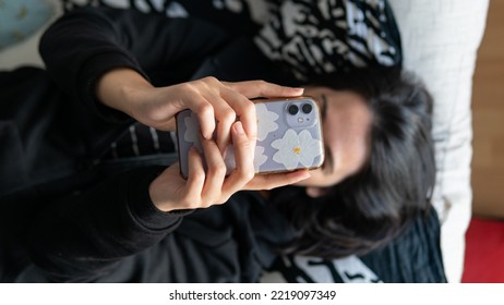 White Woman Checking The Phone, Lying In The Sofa, No Face, Horizontal View