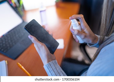 White Woman Disinfecting and Cleaning Her Phone Screen With Anti Virus Spray Made of Alcohol. Healthy Lifestyle Habits in Times of Coronavirus, Pandemic And Disease - Powered by Shutterstock