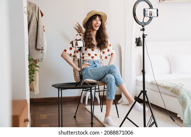 White Woman Laughing While Taking Selfie Footage On Cellphones At Home