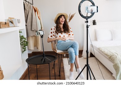 White Woman Laughing While Taking Selfie Footage On Cellphone At Home