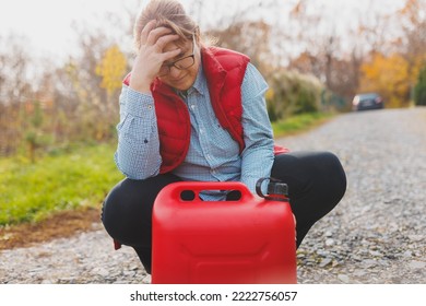 White Woman In Red Vest Holding Red Gasoline Container And Posing On Scenic Nature Country Road