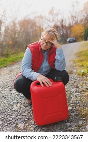 White Woman In Red Vest Holding Red Gasoline Container And Posing On Scenic Nature Country Road