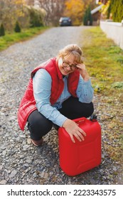 White Woman In Red Vest Holding Red Gasoline Container And Posing On Scenic Nature Country Road