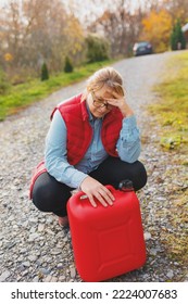 White Woman In Red Vest Holding Red Gasoline Container And Posing On Scenic Nature Country Road