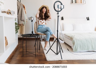 White Woman Smiling While Taking Selfie Footage On Cellphones At Home