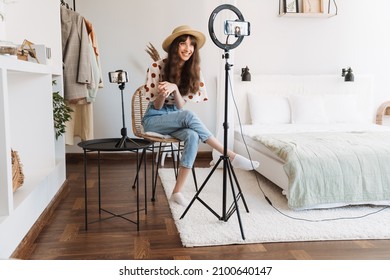 White Woman Smiling While Taking Selfie Footage On Cellphones At Home