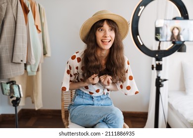 White Woman Smiling While Taking Selfie Footage On Cellphones At Home