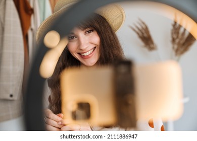 White Woman Smiling While Taking Selfie Footage On Cellphone At Home