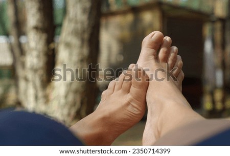 White woman's feet, natural, without pedicure in the open air