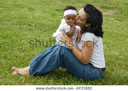 Eine weiße Frau mit einem schwarzen Baby.