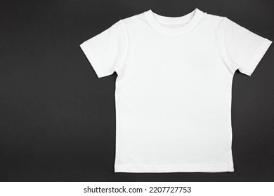 White Womens Cotton Tshirt Mockup On Black Background. Design T Shirt Template, Print Presentation Mock Up. Top View Flat Lay. Copy Space.