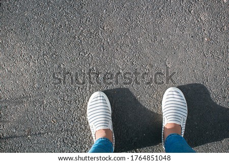 white women's shoes on asphalt during the day