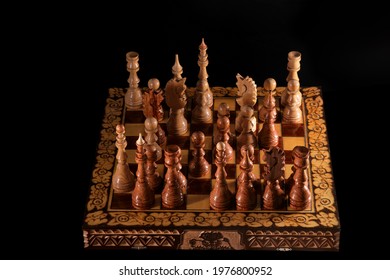 White won at chess on a vintage chessboard. Checkmate to the black king from the white queen in a chess game