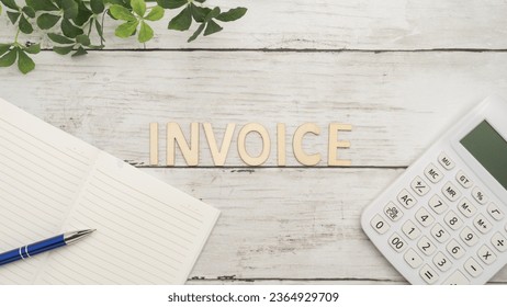 White wood background with invoice letters and calculator. - Shutterstock ID 2364929709