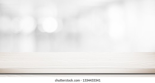 White Wood Table, Tabletop, Desk Over Blur Store With White Bokeh Light Background, Empty Wood Table, Shelf, Counter, Desk For Retail Shop Product Display Background, Banner, Mockup, Template