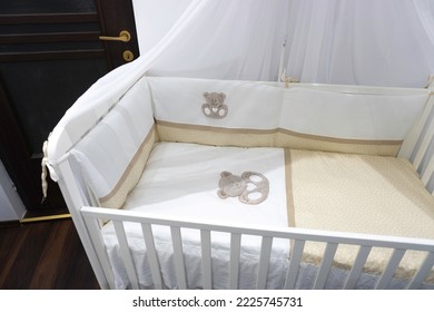 White wooden baby crib child's bed - Shutterstock ID 2225745731