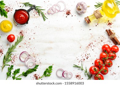 White wooden background of cooking. Spices and vegetables. Top view. Free space for your text.