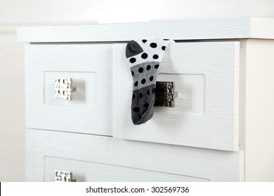 White Wooden Chest Of Drawer With Sock In Opened Drawer 