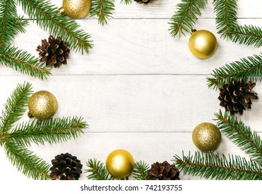 White wooden Christmas background. Border decorated fir branches and pin cones, golden balls. Letter in the center with ?opy space for holiday greetings. lovely xmas festive card. Top view. Flat - Powered by Shutterstock