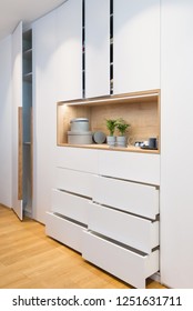 White wooden closet with open shelves in bedroom of modern house