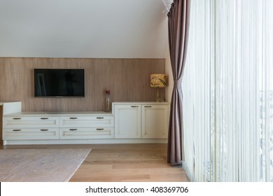 White Wooden Commode With Tv Unit Near Big Window