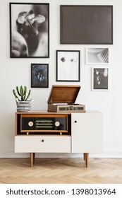 White Wooden Dresser With Vintage Radio And Old Gramophone. Gallery Of Prints On The Wall. Real Photo Concept