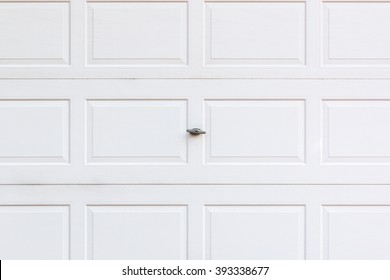 White Wooden Garage Door With Small Lock.