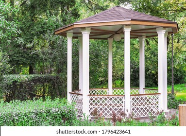 White Wooden Gazebo In A Summer Park. Garden Pergola.