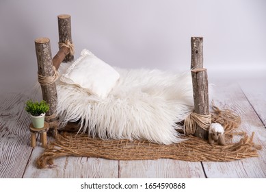 white wooden log bed for newborns