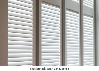 White Wooden Louver Window Decoration For Vintage Style. White Wooden Shutter With Light And Shadow.