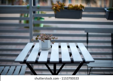 White Wooden Planks Table, Chairs And Horizontal Fence Of Cafe In The Street. Background For Product Placement. Isolated Outdoor Empty European Restaurant Or Coffee Shop Exterior. No People.