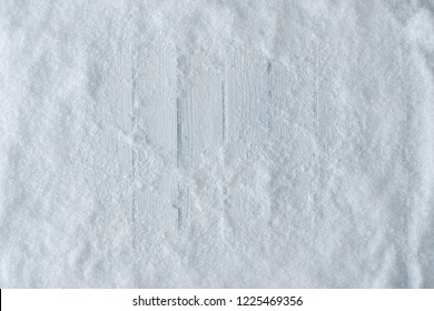 White Wooden Table Background With Snow. Winter Or Christmas Top View. Minimal Flat Lay.