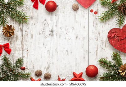 White Wooden Table With Christmas Tree And Decorations Top View. Free Space For Text. Christmas Balls, Bow, Walnut, Pine Cone, Stars And Gift Beside.