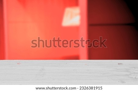 white wooden table in red room
