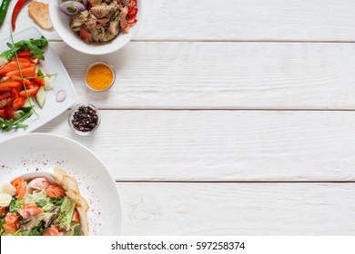 White Wooden Table With Warm Salads Free Space. Top View On Kitchen Desk With Meat Side Dishes, Flat Lay. Buffet, Banquet, Party, Menu Concept