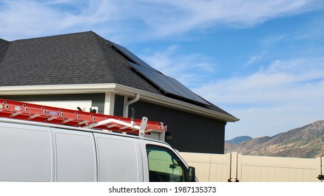 White Work Van Parked In Front Of Solar Panel Installation.