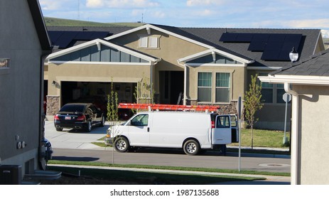 White Work Van Parked In Front Of Solar Panel Installation.