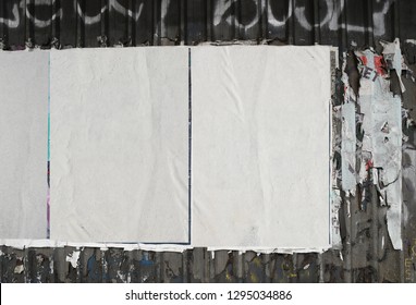 White Worn Weathered Street Posters Hanging On Urban Abandoned Warehouse Exterior Wall Background