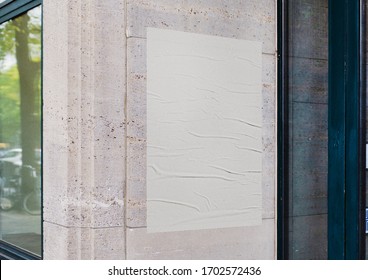 White wrinkled poster template. Glued paper mockup. Blank wheatpaste on textured wall. Empty street art sticker mock up. Clear urban glued advertising canvas. - Shutterstock ID 1702572436