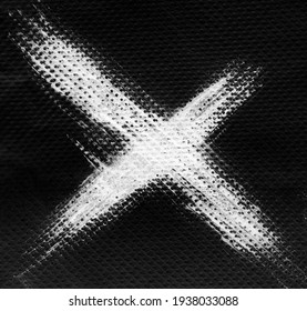 White X ink letter on black background, napkin tissue texture