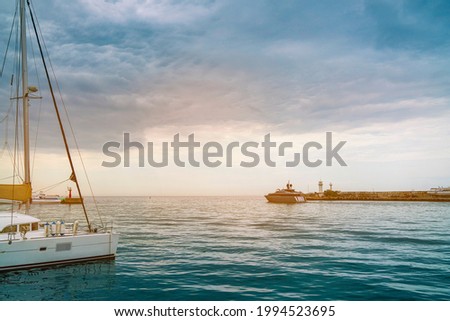 white yacht on the background of the sea evening landscape. berth with a yacht at sunset.