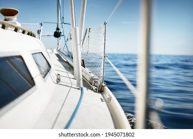 White Yacht Sailing In The North Sea After The Storm. Norway. Close-up Of Boat Side Railing. Clear Blue Sky, Soft Sunlight. Transportation, Cruise, Recreation, Regatta, Sport, Leisure Activity