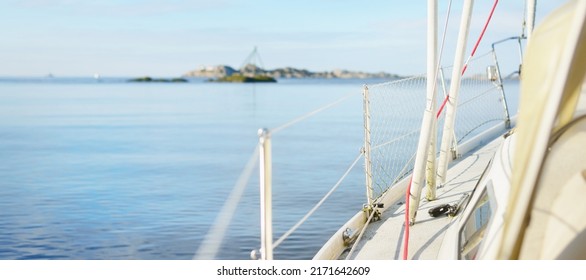 White Yacht Sailing In The North Sea After The Storm. Norway. Close-up Of Boat Side Railing. Clear Blue Sky, Soft Sunlight. Transportation, Cruise, Recreation, Regatta, Sport, Leisure Activity