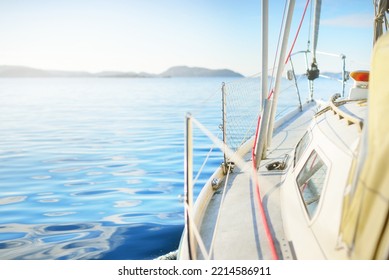 White Yacht Sailing In The North Sea After The Storm. Norway. Close-up Of Boat Side Railing. Clear Blue Sky, Soft Sunlight. Transportation, Cruise, Recreation, Regatta, Sport, Leisure Activity