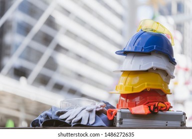 white, yellow and blue hard safety helmet hat for safety project of workman as engineer or worker, on concrete floor in construction site. concept of Banner work safety first, health and protections