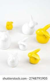 White and Yellow Ceramic Easter Bunny Figurines on White Background