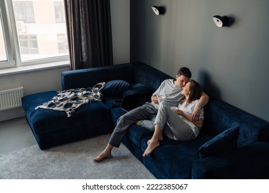 White Young Couple Drinking Coffee While Resting On Couch Together At Home