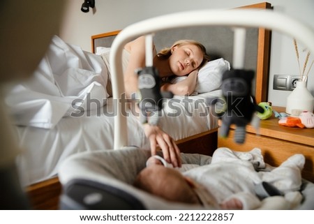 Similar – Relaxed mother and sons playing over the bed