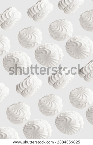 White zephyr marshmallows pattern on white background.